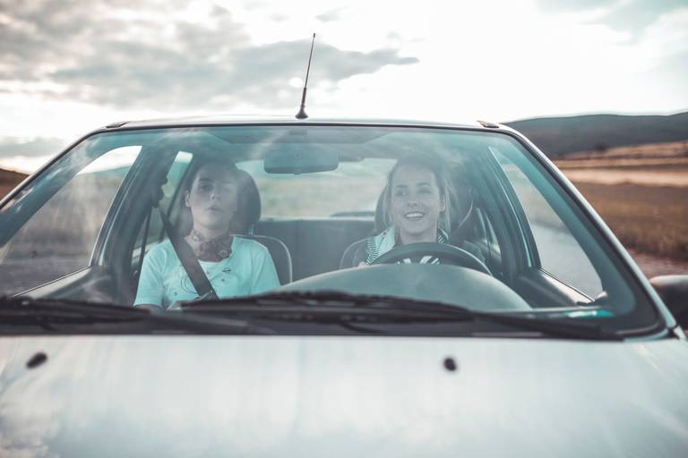 two women driving a car